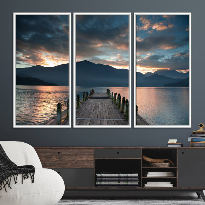 The Mountain Lake Wood Pier Canvas Wall Art depicts a serene lake and mountains, enhancing the beauty of any space.