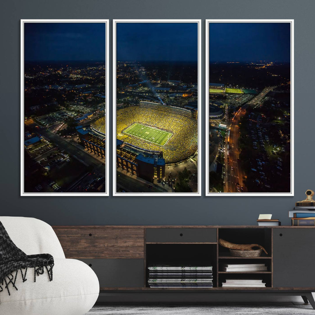 Aerial view of Michigan Stadium at night, surrounded by city lights, depicted on a Michigan Wolverines wall art canvas print.