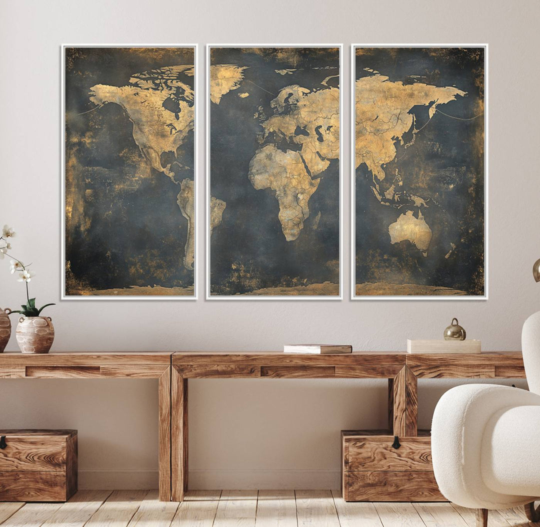 The Grunge World Map Canvas Wall Art features golden tones and is displayed against a white-paneled wall.