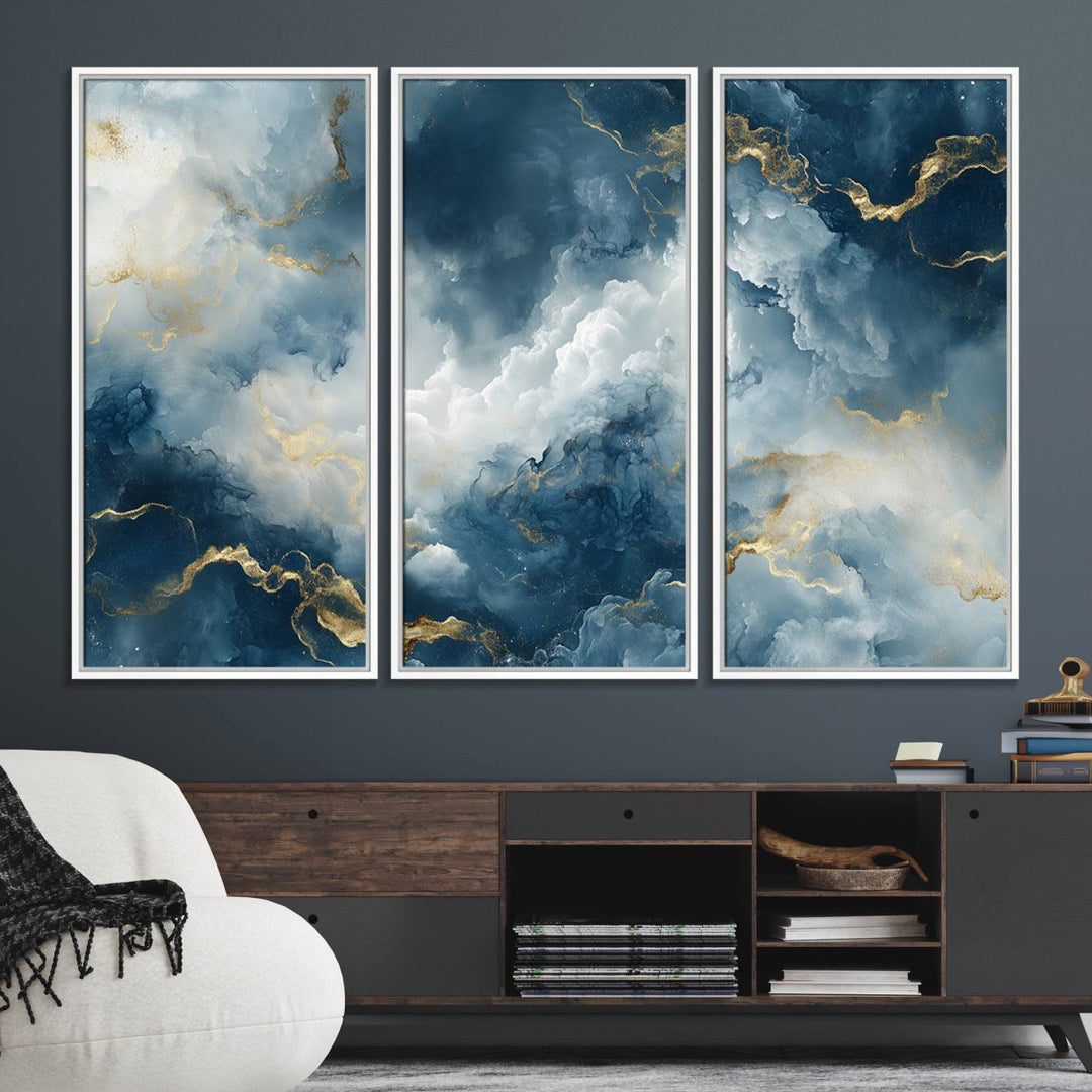 The "Large Abstract Print - Luxe Blue and Gold Abstract Canvas Wall Art" features a bold cloudscape design with swirling white patterns, ideal for modern home decor in living rooms or offices.