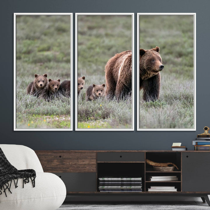 The large canvas print titled "Queen of the Tetons, 399 Grizzly Bear Cubs" showcases majestic wildlife photography of a bear and her cubs walking through the grass. This stunning canvas wall art, handmade in the USA, adds a charming touch to any room with its rustic decor appeal.