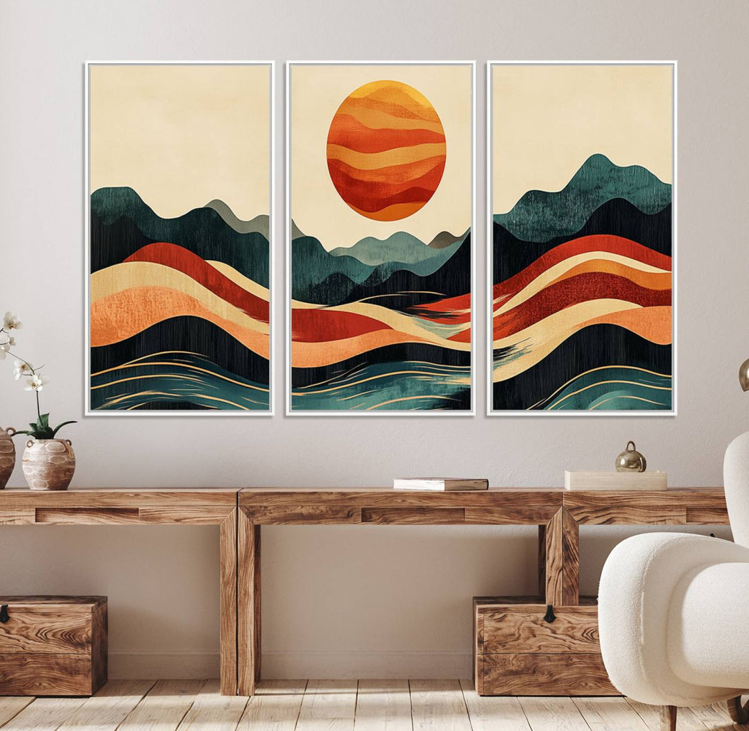 The Mountain Triptych wall art, featuring a design of the sun, mountains, and waves, is displayed prominently on the wall.