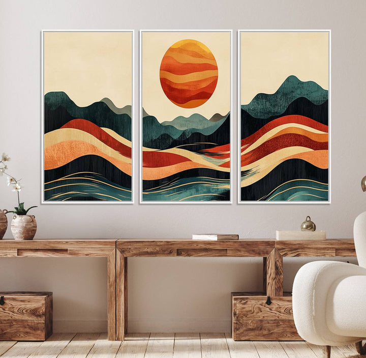 The Mountain Triptych wall art, featuring a design of the sun, mountains, and waves, is displayed prominently on the wall.