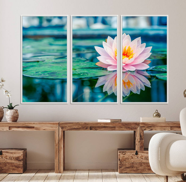 The Lotus Flower Canvas Print showcases a pink water lily with a yellow center gracefully floating on a calm pond.