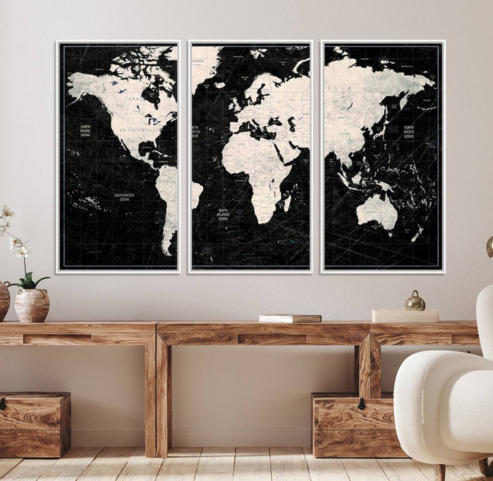A bold global style framed black and white world map canvas print, presented in three panels, perfect for modern home or office decor.