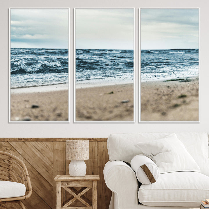 A moody ocean scene with gentle waves washing onto a sandy beach under a cloudy sky, creating a peaceful and coastal atmosphere.