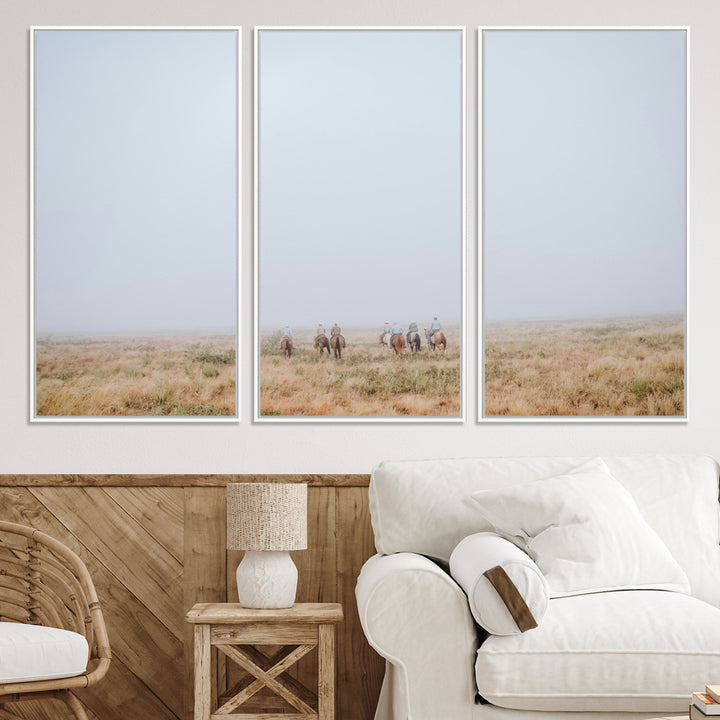 A group of horseback riders moving through a fog-shrouded field, evoking a calm Western scene with golden grasses and soft horizons.