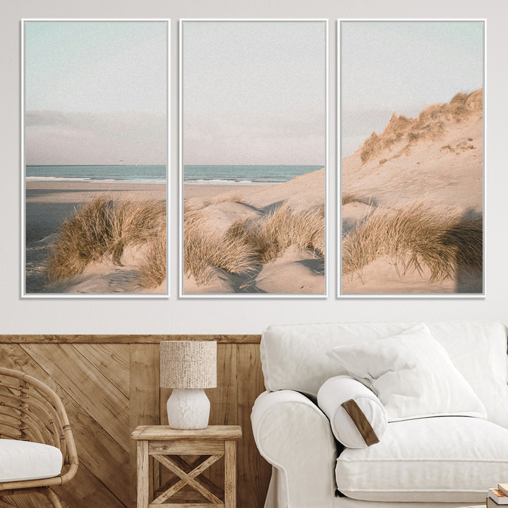 Soft pastel-toned beach scene with sand dunes, windswept grasses, and a calm ocean horizon, creating a serene coastal atmosphere.