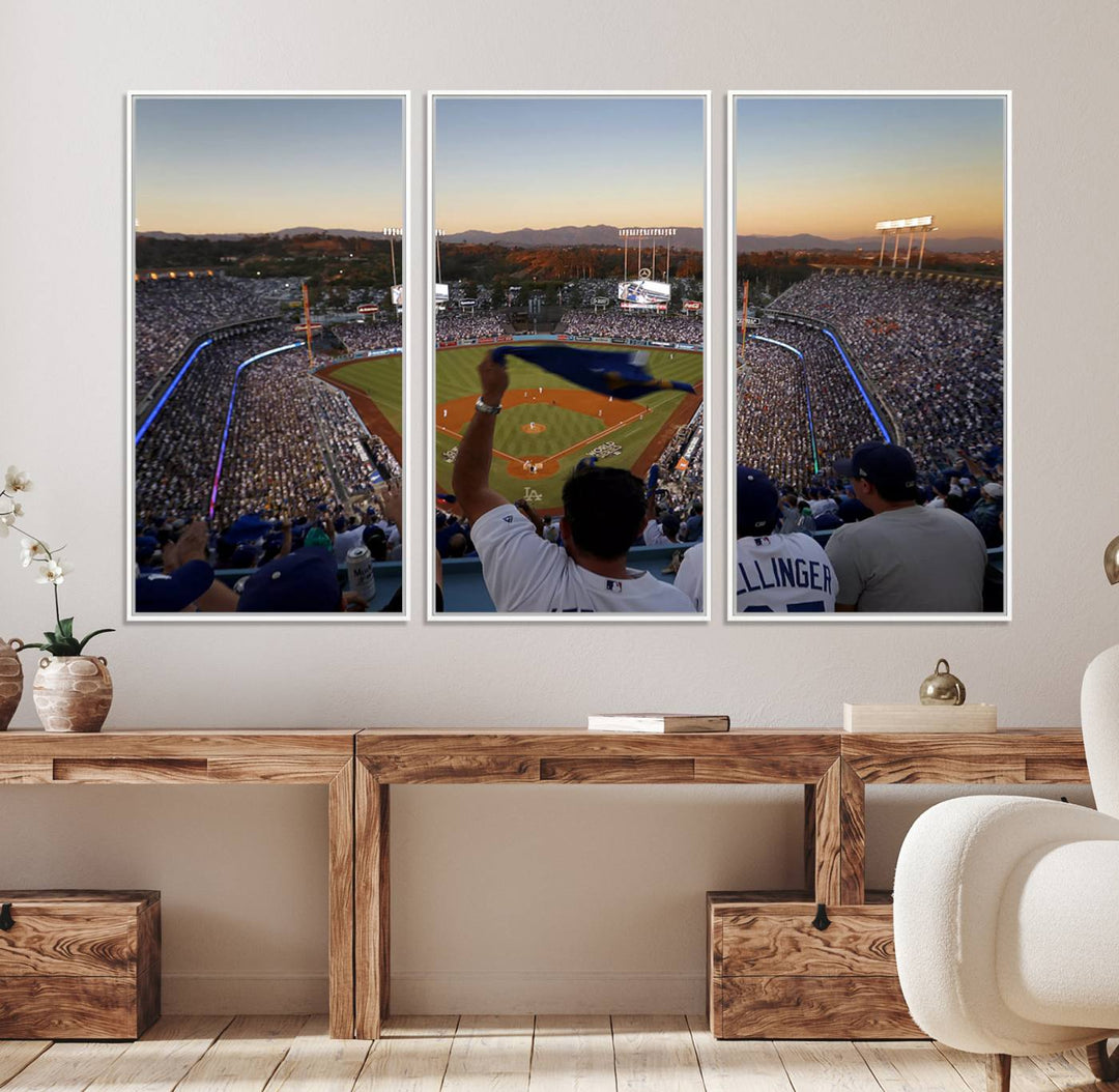 A triple canvas wall art captures the scene at Dodger Stadium, with fans cheering as the sun sets and a flag waving on the field.