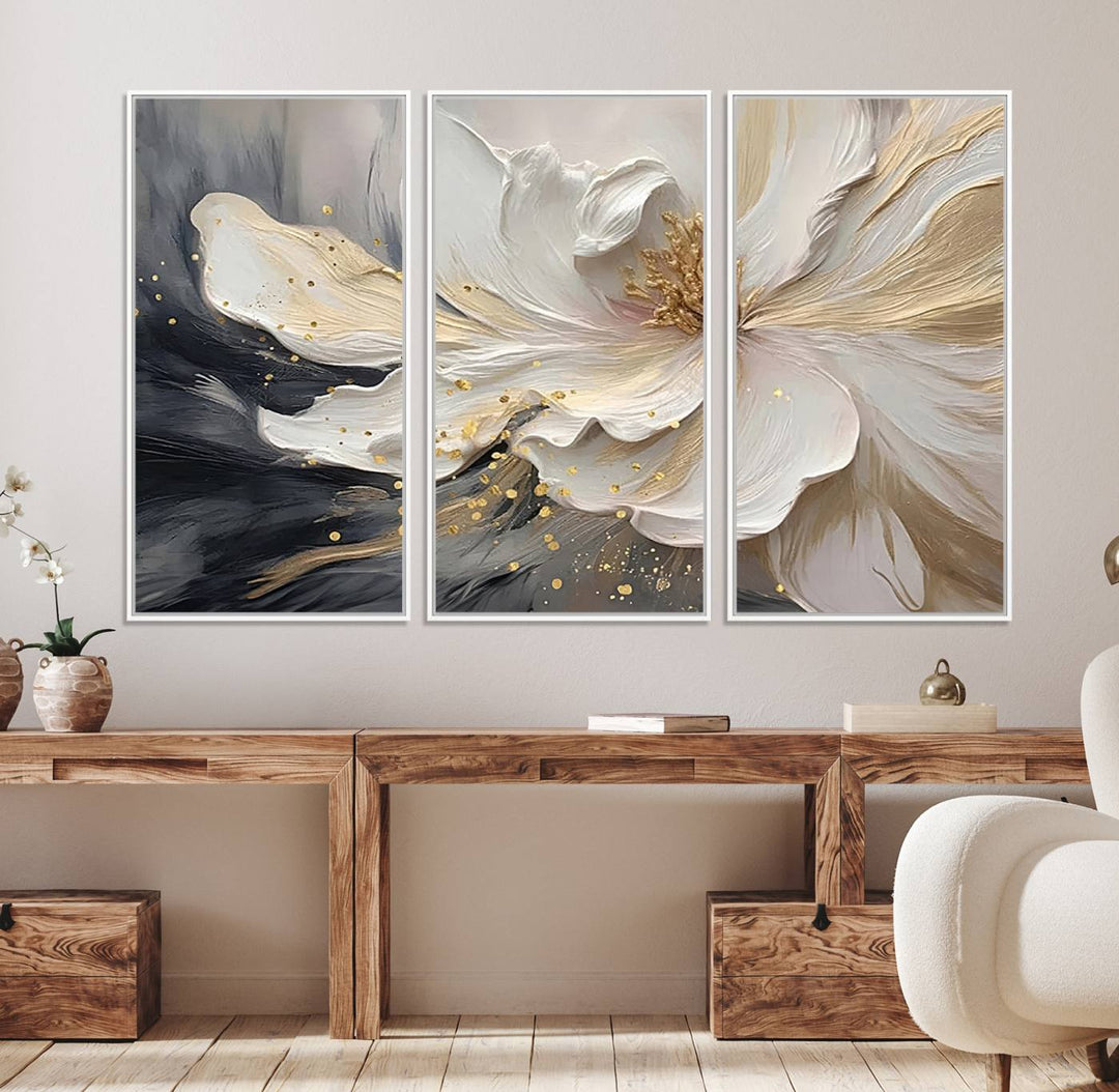 Elegant White and Gold Floral Triptych Canvas Art, a modern textured flower painting for home or office decor, features a blurred gray background.