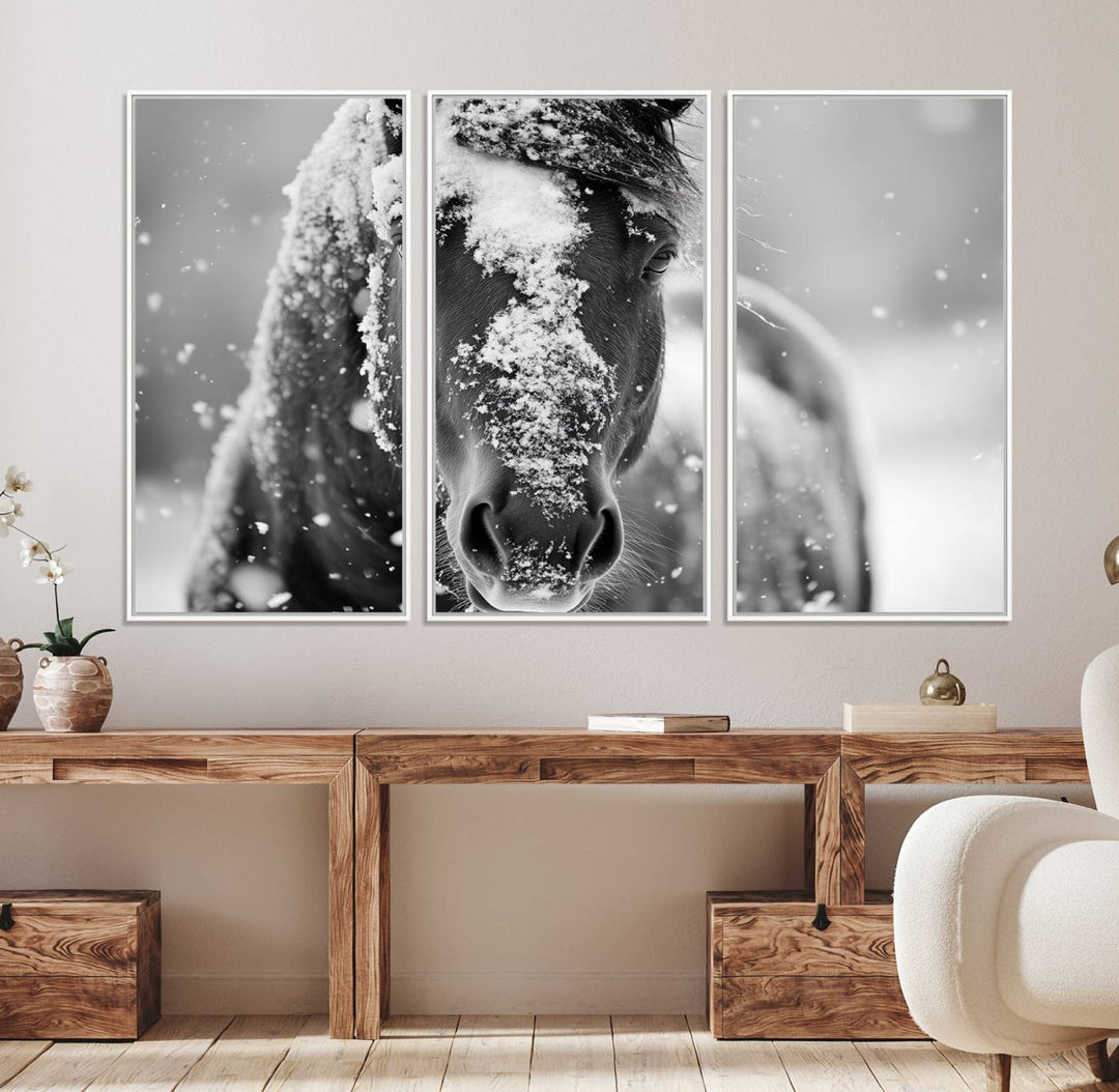 The Black and White Horse Winter Wall Art features a majestic horse with snow-covered hair set against a serene winter backdrop.