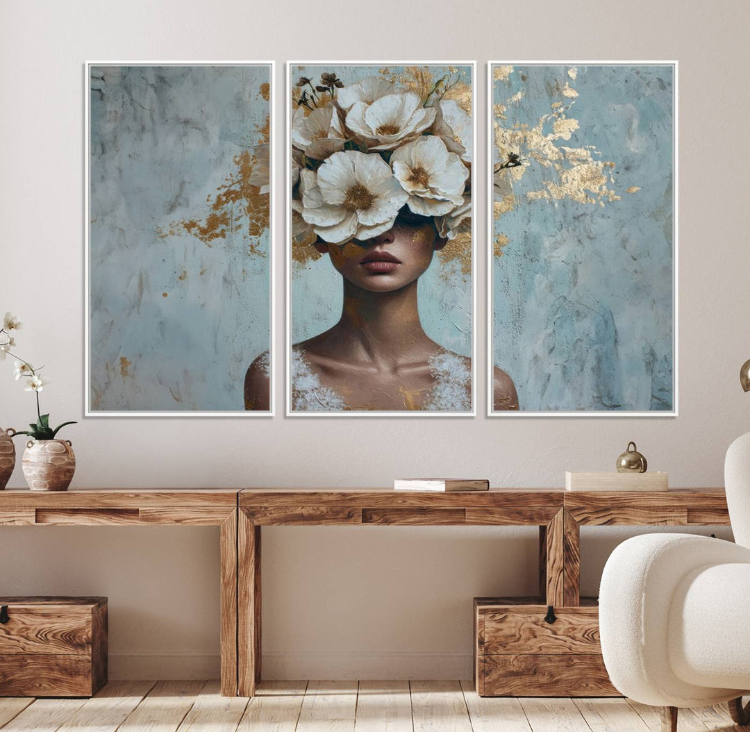 Golden Petal Wall Art: A womans face adorned with a gold floral design on a teal background, presented in a 3-panel modern glam canvas.