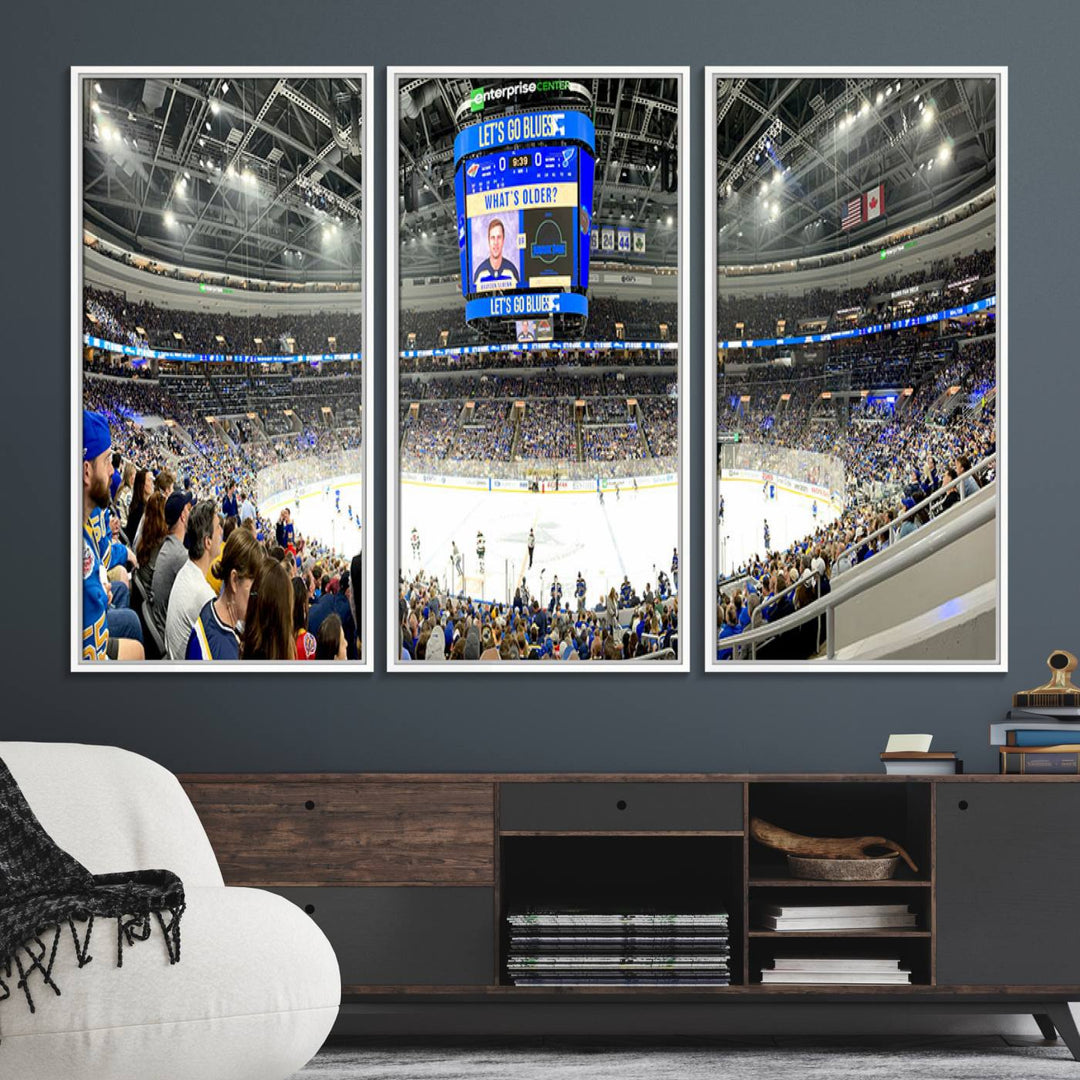 Wall art prints depicting the bustling scenes of the St. Louis Blues being cheered on by a full house at the Enterprise Center, beneath a large scoreboard.