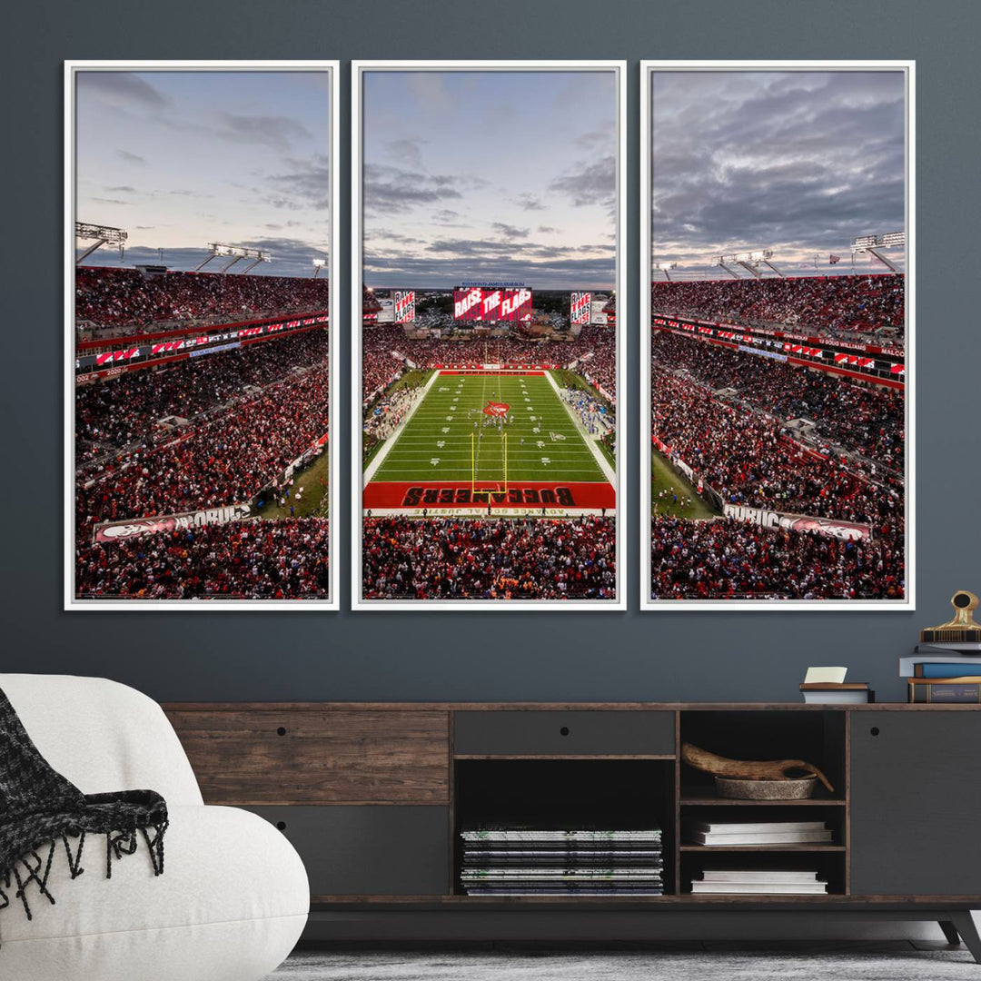 The wall art captures a stunning scene of Raymond James Stadium bathed in the warm hues of sunset. The sky, filled with clouds, provides a dramatic contrast to the vibrant lighting on the field, encapsulating the dynamic energy of a football game.