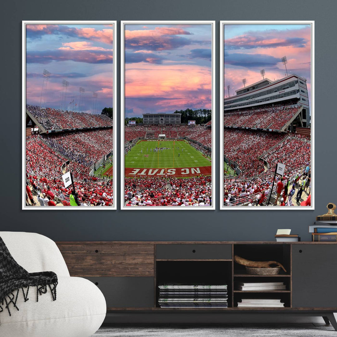 The wall art captures an NC State Wolfpack game under a vibrant sunset on triple canvas.