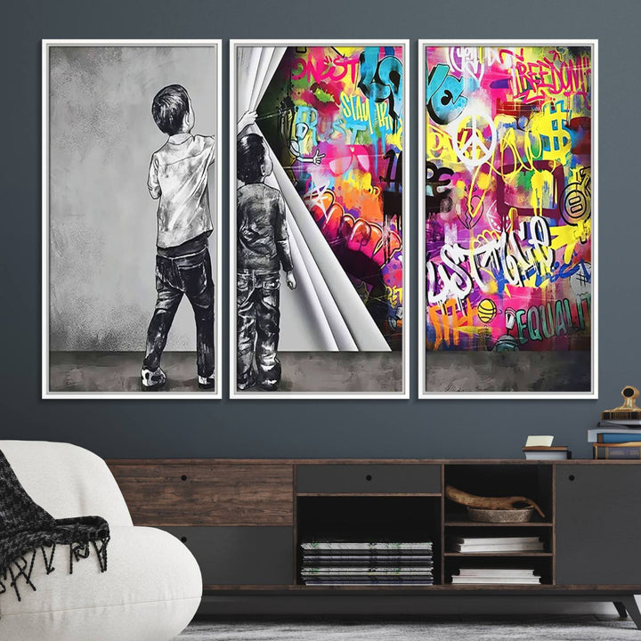 The Banksy Print - Street Art Canvas features a vibrant and bold image of two children lifting a curtain to reveal colorful graffiti. It's ready to hang, adding an urban modern decor vibe.