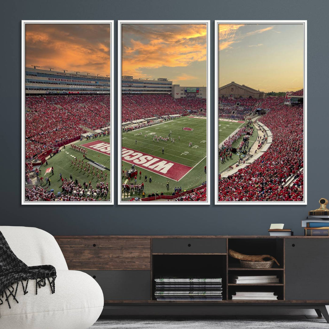 The wall features a Wisconsin Badgers wall art canvas print, capturing the vibrant atmosphere of a full Camp Randall Stadium at sunset.