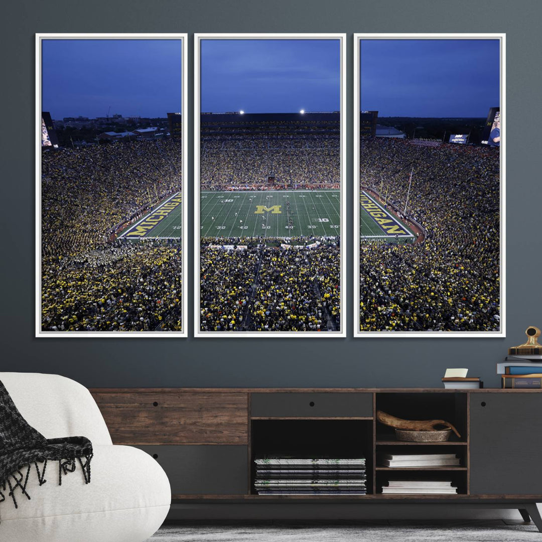 Wall art featuring an aerial shot of Michigan Stadium at dusk, showcasing the University of Michigan Wolverines M logo.