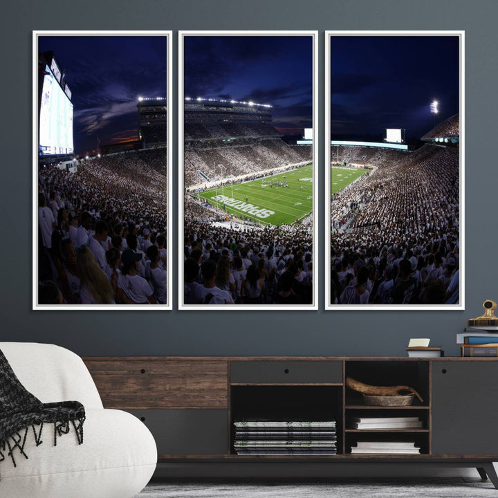 A packed football stadium at night, with bright lights and fans in white, depicted in a Michigan State Spartans Stadium wall art.