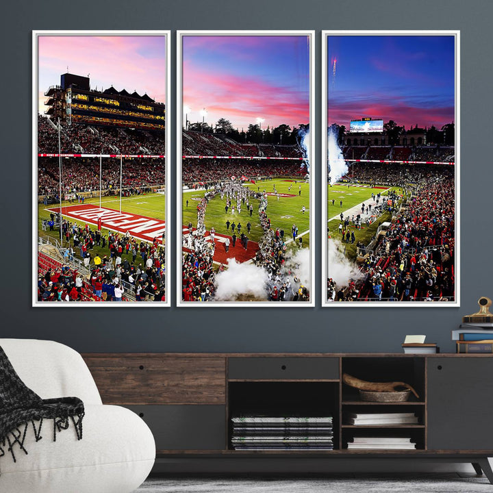 The wall art features a canvas print of the Stanford Cardinal football team, capturing players, fireworks, and smoke against the backdrop of a sunset at Stanford Stadium.