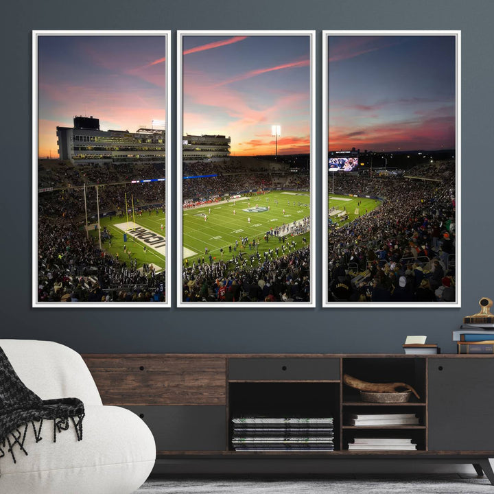 This wall art canvas print captures UCONN Huskies fans energizing a sunset scene at East Hartfords Pratt & Whitney Stadium.