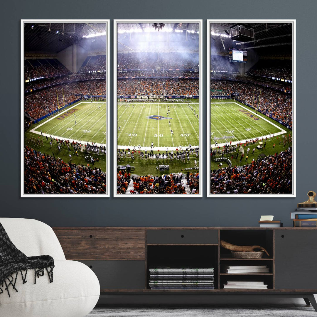 The modern living room features an Alamodome wall art canvas print, depicting a stadium filled with spectators for a UTSA Roadrunners game.