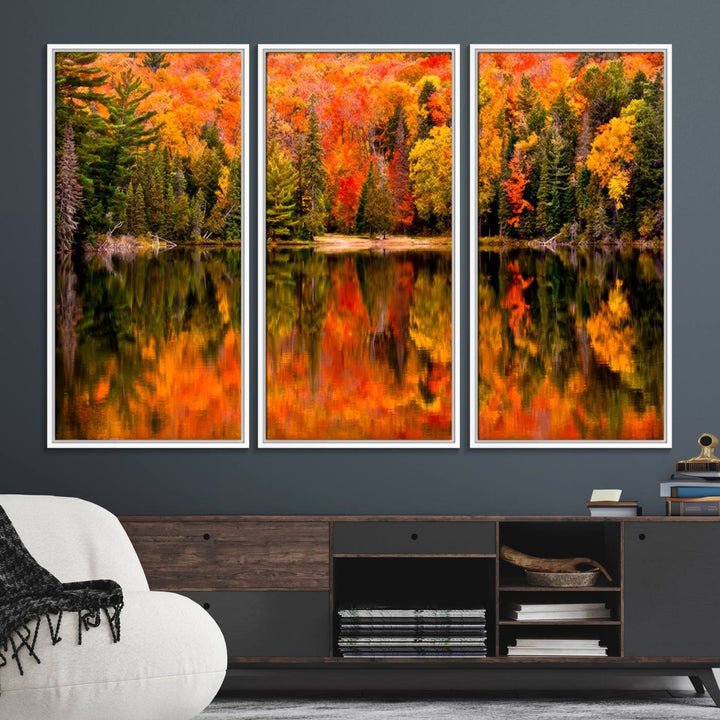 Autumn Forest Reflection Wall Art: a vibrant triptych canvas featuring fall foliage with red, orange, and yellow leaves over a calm lake.