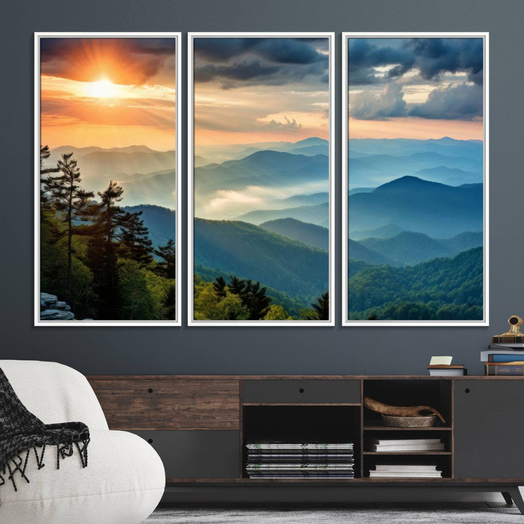 The wall art, titled Sunrise Over Mountain Range, is a canvas print that beautifully depicts layers of hills, scattered trees, and a partly cloudy sky.