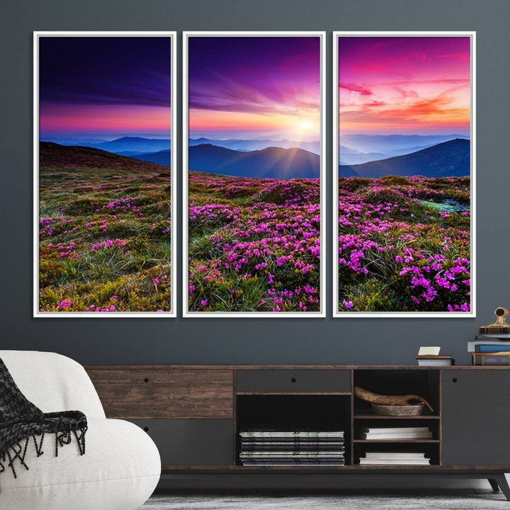 A 3-panel landscape photography canvas of a sunset over mountain meadows with purple wildflowers decorates the wall.