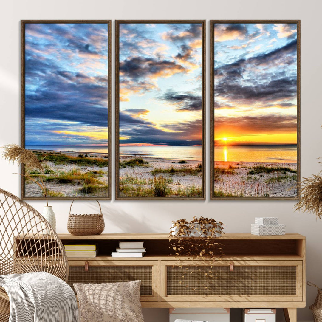 The Sunset On The Ocean canvas wall art features a beautiful beach sunset with grass and clouds.