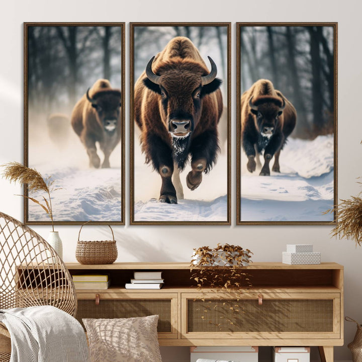 Wall art titled Cow Bighorn shows three bison running through snow in a forest.