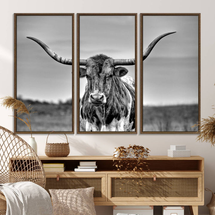 The Texas Longhorn Cow wall art, divided into three panels, is of gallery quality and displayed on a dark wall.