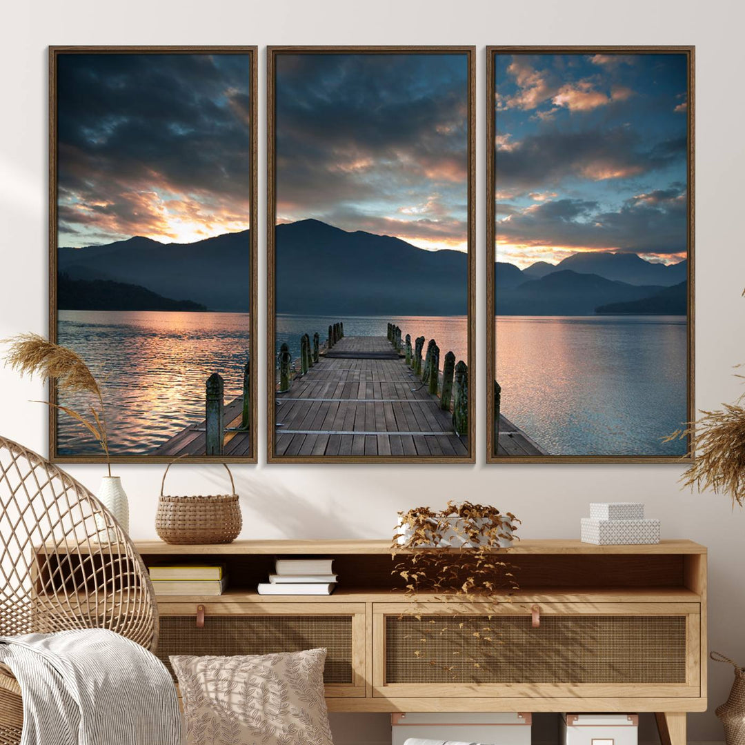 The Mountain Lake Wood Pier Canvas Wall Art depicts a serene lake and mountains, enhancing the beauty of any space.