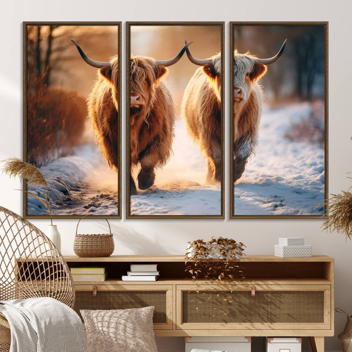 The wall art is a Scottish Highland Cow Horn canvas print featuring cows on a snowy path bathed in warm sunlight, serving as a rustic decor piece.