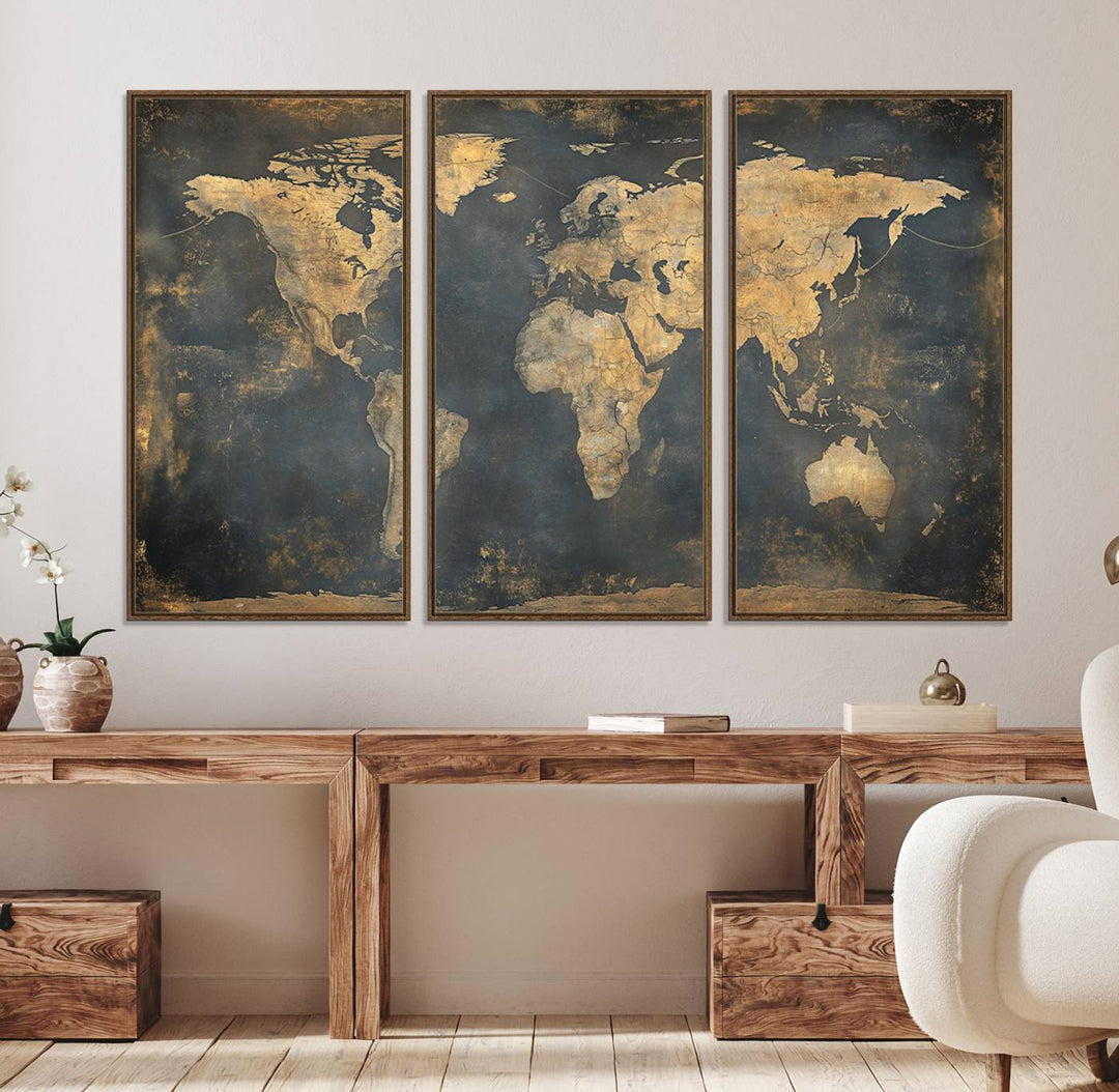 The Grunge World Map Canvas Wall Art features golden tones and is displayed against a white-paneled wall.