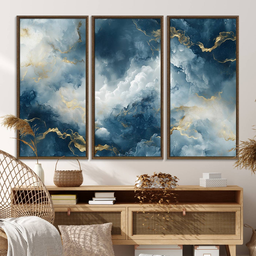 The "Large Abstract Print - Luxe Blue and Gold Abstract Canvas Wall Art" features a bold cloudscape design with swirling white patterns, ideal for modern home decor in living rooms or offices.