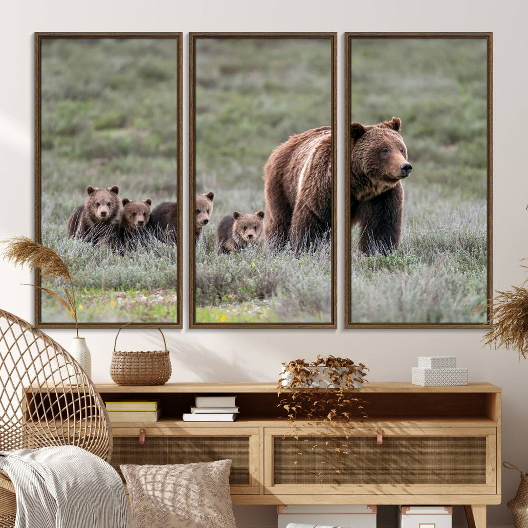 The large canvas print titled "Queen of the Tetons, 399 Grizzly Bear Cubs" showcases majestic wildlife photography of a bear and her cubs walking through the grass. This stunning canvas wall art, handmade in the USA, adds a charming touch to any room with its rustic decor appeal.