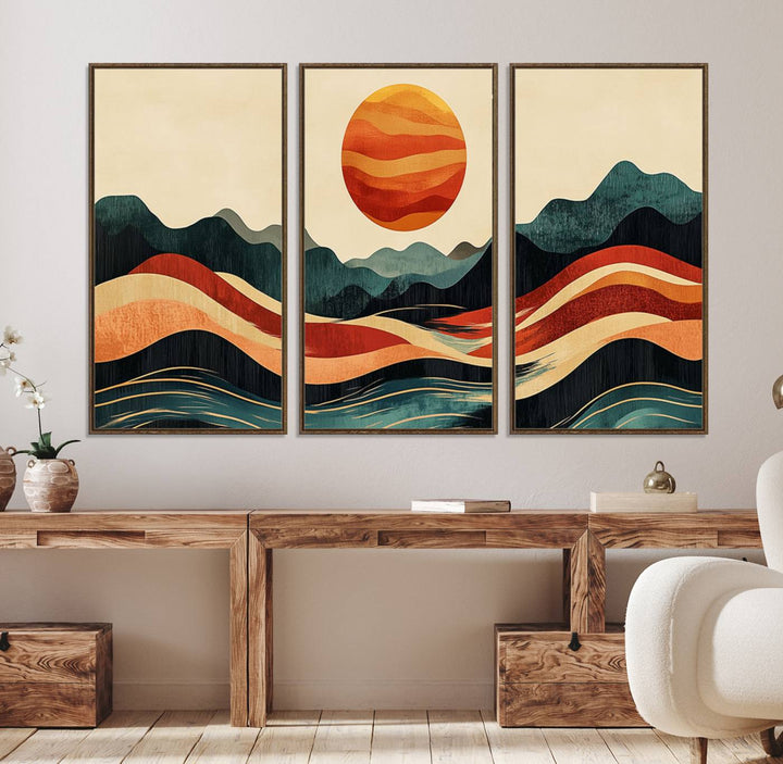 The Mountain Triptych wall art, featuring a design of the sun, mountains, and waves, is displayed prominently on the wall.