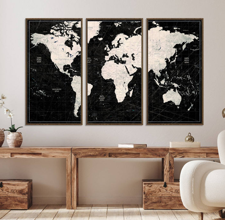 A bold global style framed black and white world map canvas print, presented in three panels, perfect for modern home or office decor.