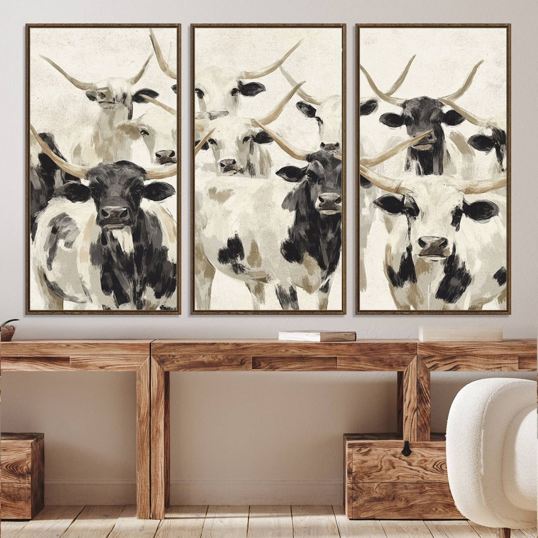 Canvas print titled Longhorn Texas Cow Drawing, depicting longhorn cattle with black and white markings, made in the USA, displayed on the wall.