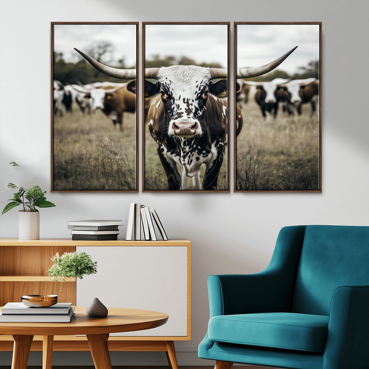 Canvas of a speckled Texas longhorn standing boldly in a field with a herd behind, perfect for rustic western or farmhouse wall decor.