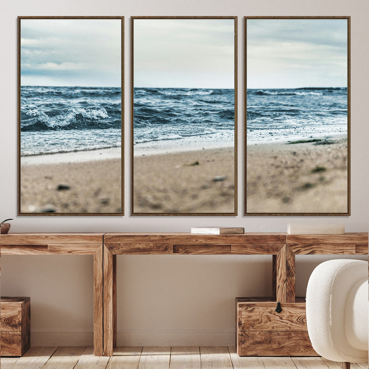 A moody ocean scene with gentle waves washing onto a sandy beach under a cloudy sky, creating a peaceful and coastal atmosphere.