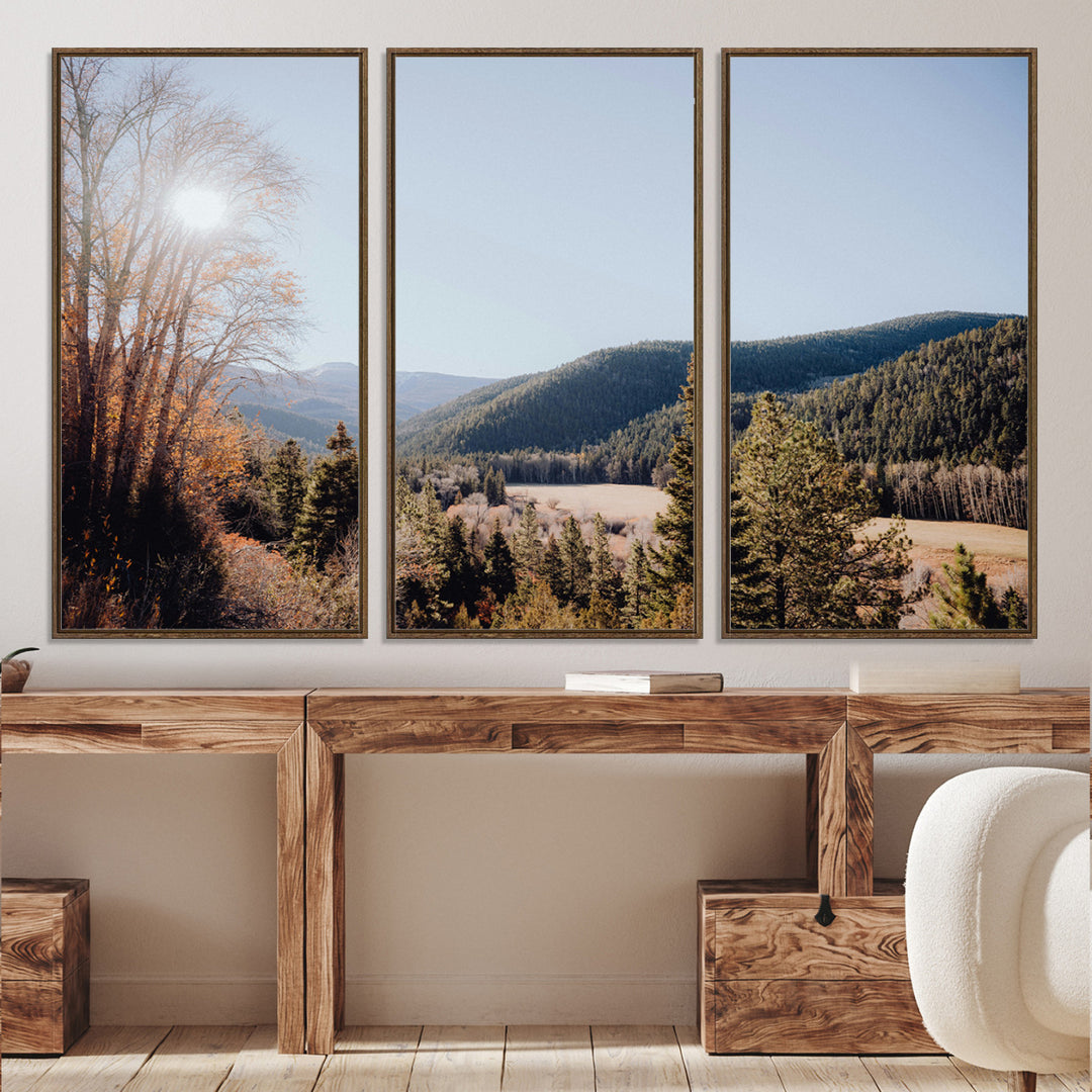 A scenic mountain valley with pine trees and autumn foliage under a clear sky, bathed in golden sunlight, creating a peaceful and rustic landscape.