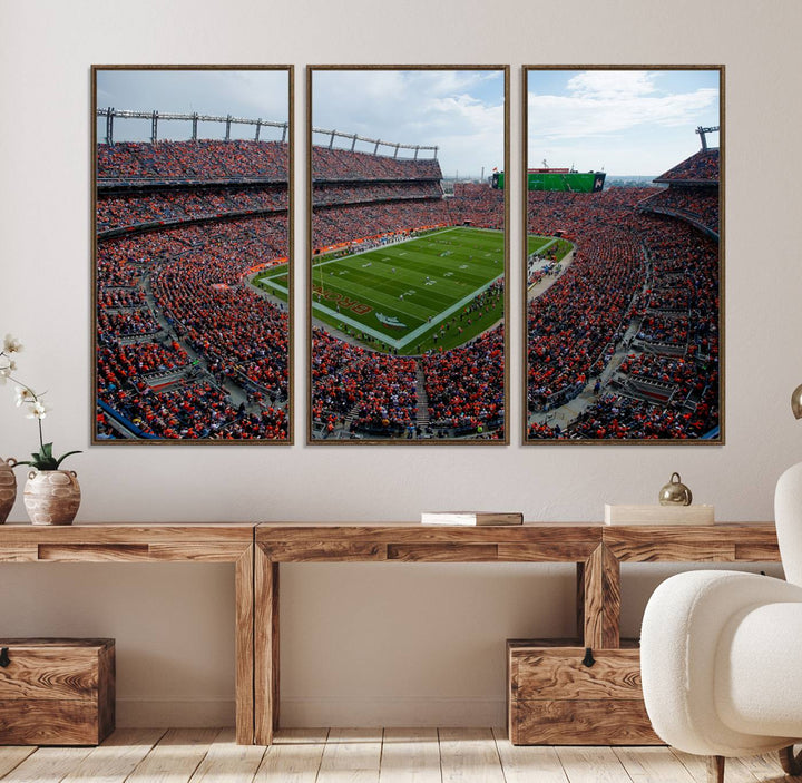 The Denver Broncos Football Print features a vibrant, fan-filled orange stadium overlooking the football field.