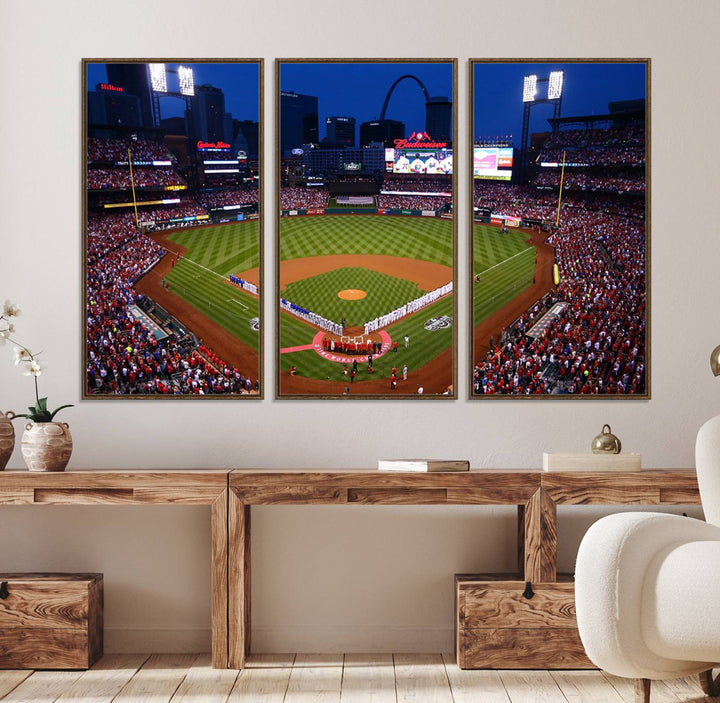 A Cardinals wall art canvas print depicts Busch Stadium with players lined up on the field and a full audience under the lights, capturing the vibrant atmosphere.