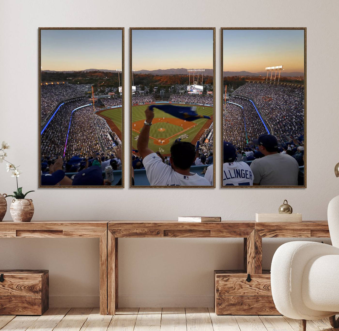 A triple canvas wall art captures the scene at Dodger Stadium, with fans cheering as the sun sets and a flag waving on the field.