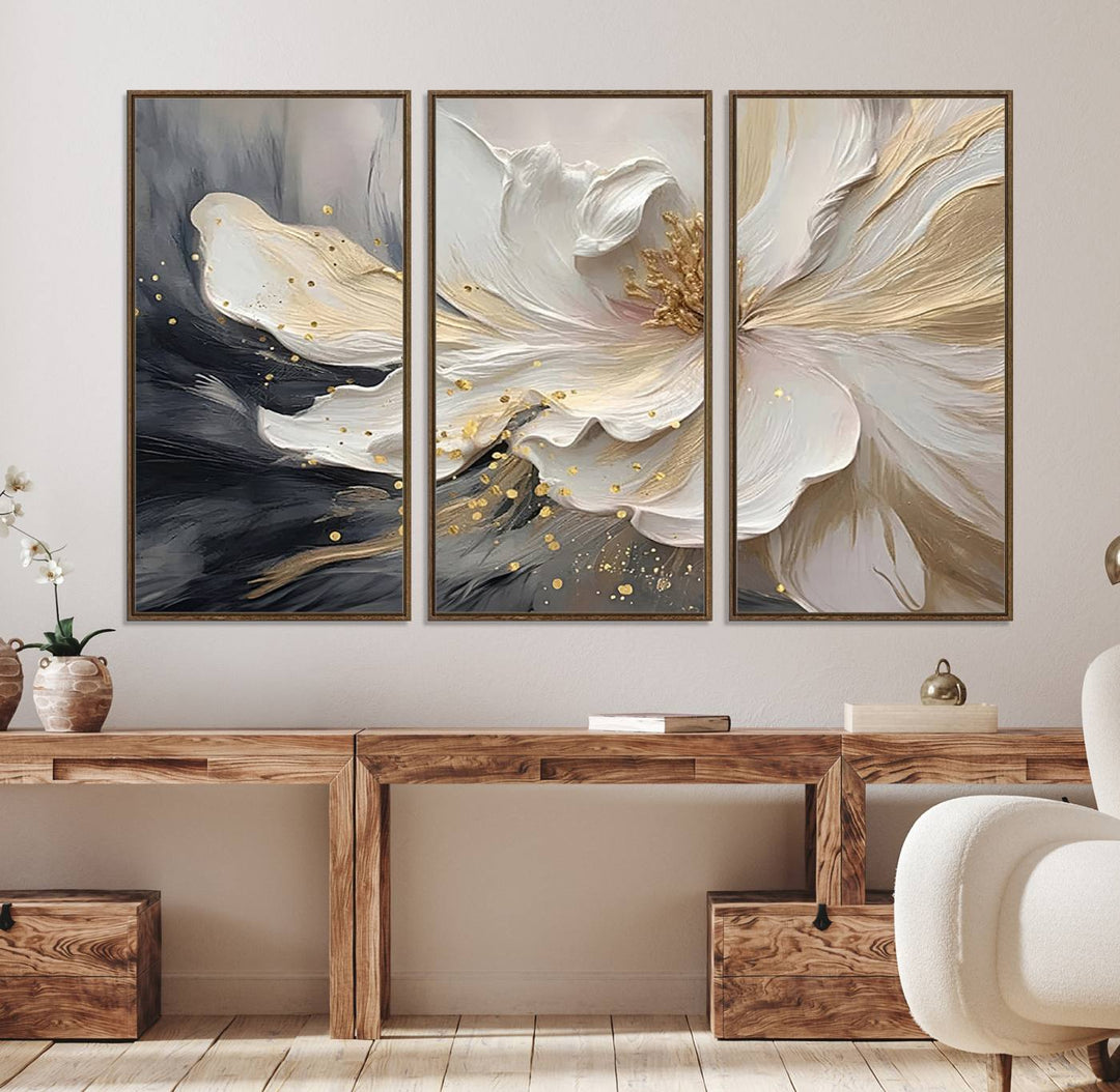 Elegant White and Gold Floral Triptych Canvas Art, a modern textured flower painting for home or office decor, features a blurred gray background.