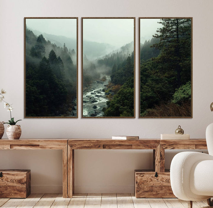 The Misty Forest Wall Art features a serene landscape with a misty river and evergreens, ideal for enhancing the ambiance of any living room or cabin.