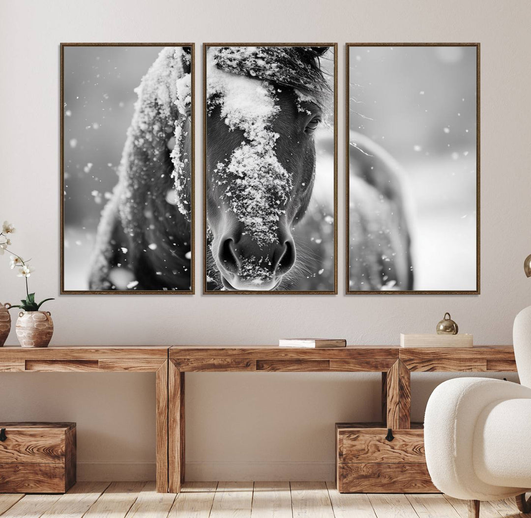 The Black and White Horse Winter Wall Art features a majestic horse with snow-covered hair set against a serene winter backdrop.