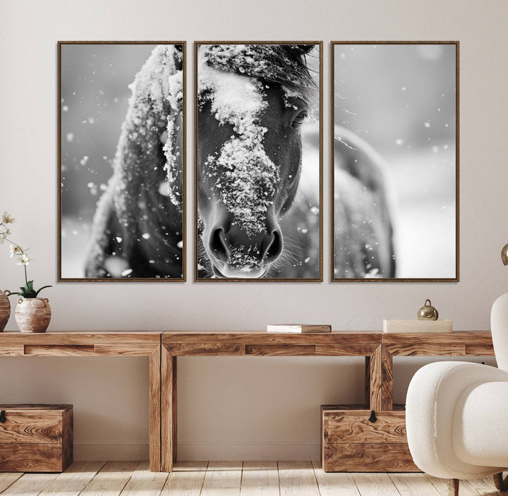 The Black and White Horse Winter Wall Art features a majestic horse with snow-covered hair set against a serene winter backdrop.